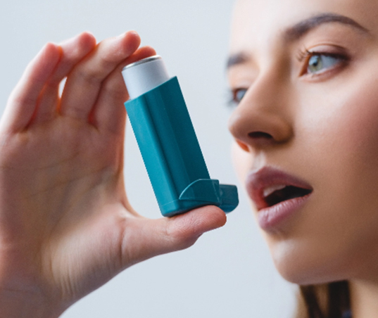 Woman with an asthma inhaler.