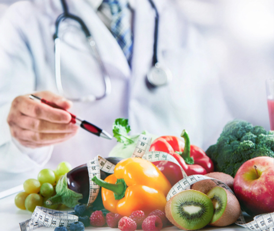 The prevention of cardiovascular disease. A physician points to various fruit and vegetables with a tape measure decorated on top.